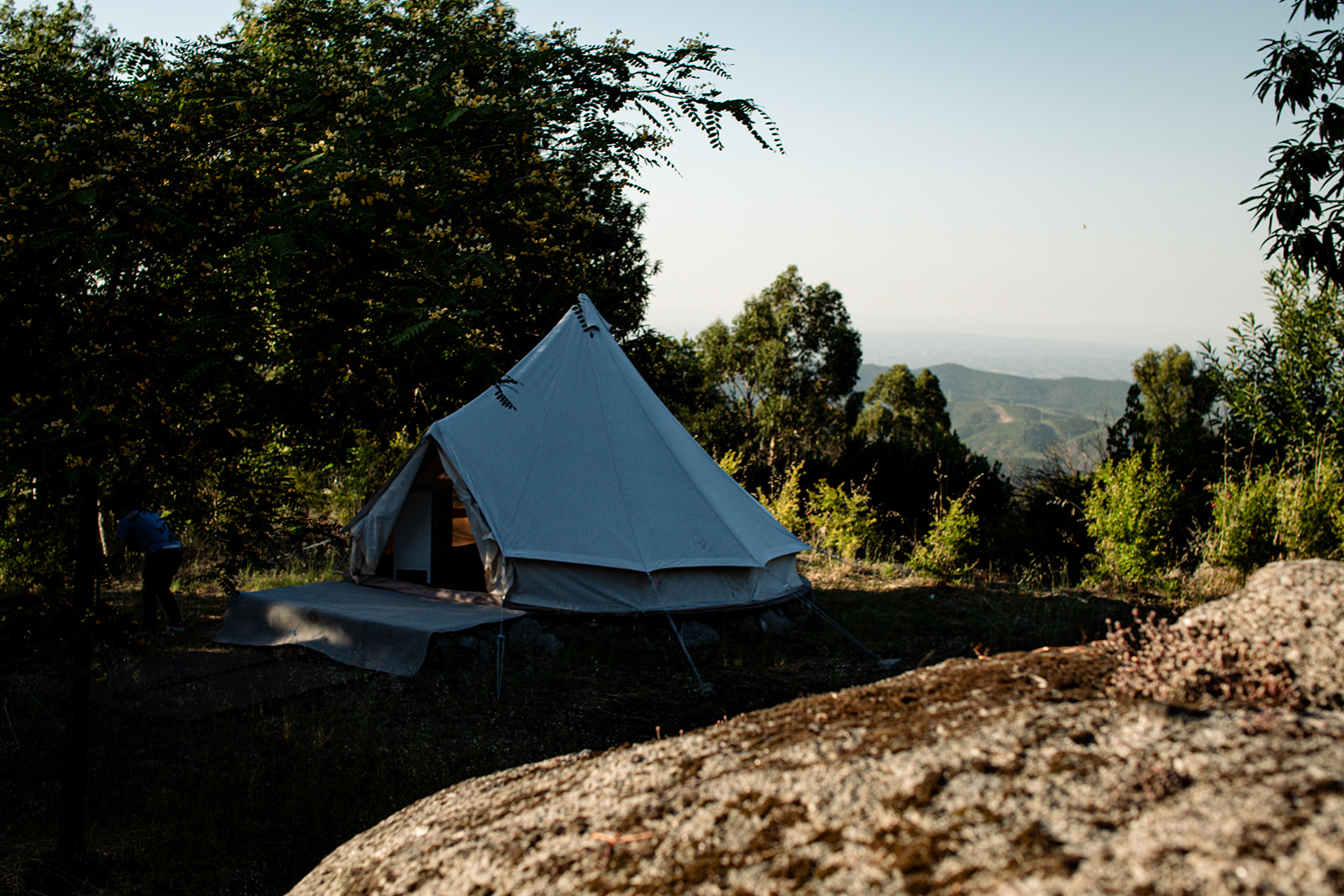 Interior of a glamping bell tent with comfortable bedding at Bodhi Bhavan