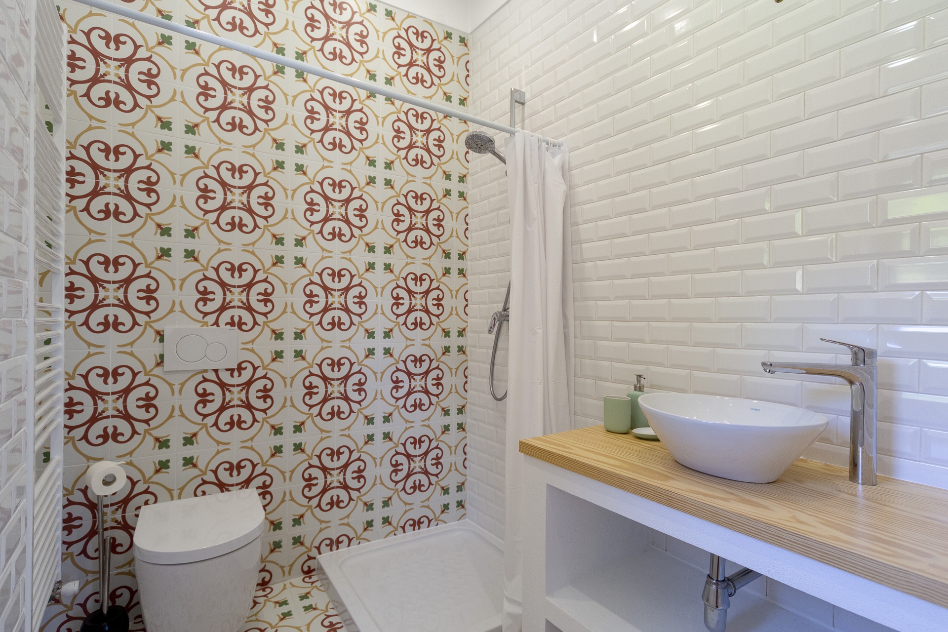Ensuite bathroom with decorative tiles at Bodhi Bhavan